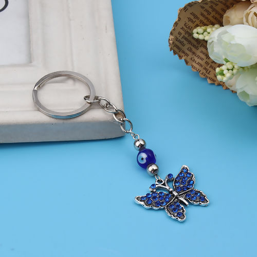 Image de Porte-Clés Papillon Argent Vieilli Œil Mauvais à Strass Bleu 11cm x 3cm, 1 Pièce